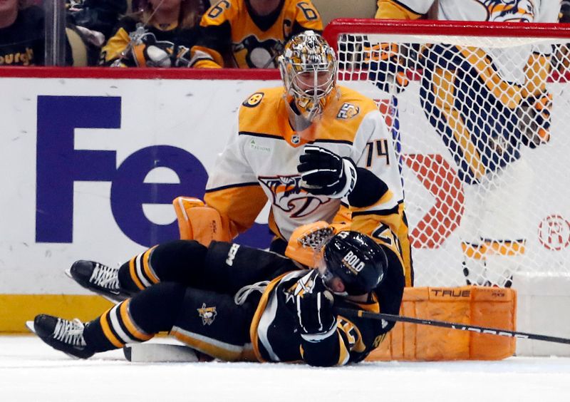 Apr 15, 2024; Pittsburgh, Pennsylvania, USA;  Pittsburgh Penguins right wing Bryan Rust (17) gets tangled up with  Nashville Predators goaltender Juuse Saros (74) during the second period at PPG Paints Arena. Mandatory Credit: Charles LeClaire-USA TODAY Sports