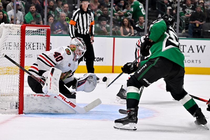Mar 8, 2026; Dallas, Texas, USA; Chicago Blackhawks goaltender Arvid Soderblom (40) faces a shot by Dallas Stars center Wyatt Johnston (53) during the second period at the American Airlines Center. Mandatory Credit: Jerome Miron-Imagn Images