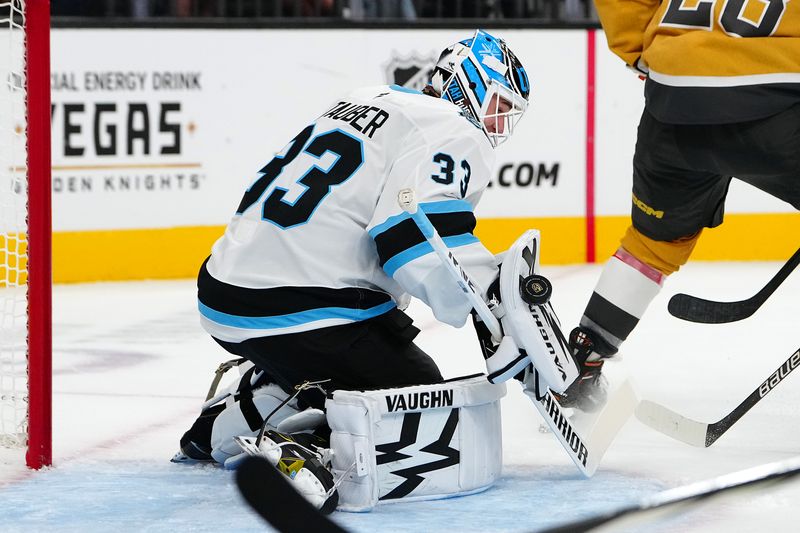 Sep 27, 2024; Las Vegas, Nevada, USA; Utah Hockey Club goaltender Jaxson Stauber (33) makes a blocker save against the Vegas Golden Knights during the second period at T-Mobile Arena. Mandatory Credit: Stephen R. Sylvanie-Imagn Images