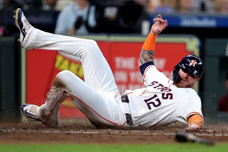 Sep 7, 2024; Houston, Texas, USA; Houston Astros right fielder Ben Gamel (12) slides across home plate to score a run against the Arizona Diamondbacks during the fourth inning at Minute Maid Park. Mandatory Credit: Erik Williams-Imagn Images
