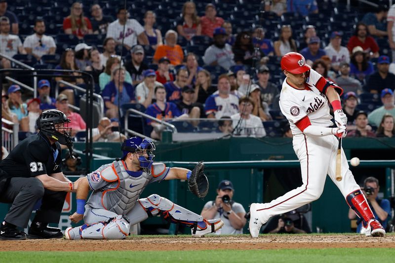 Jun 3, 2024; Washington, District of Columbia, USA; Washington Nationals first base Joey Meneses (45) hits a sacrifice fly RBI against the New York Mets during the ninth inning at Nationals Park. Mandatory Credit: Geoff Burke-USA TODAY Sports