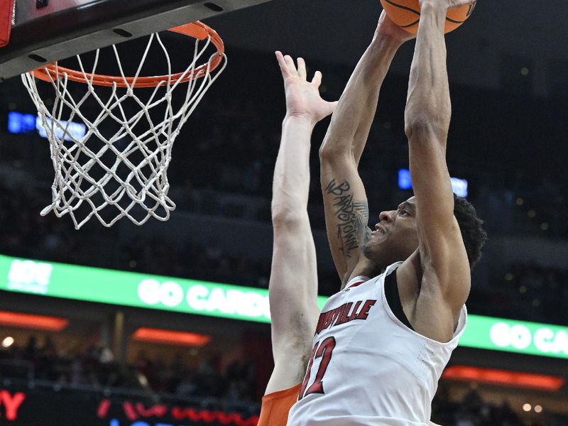 Feb 18, 2023; Louisville, Kentucky, USA;  Louisville Cardinals forward JJ Traynor (12) attempts to dunk against Clemson Tigers forward Ben Middlebrooks (10) during the second half at KFC Yum! Center. Louisville defeated Clemson 83-73. Mandatory Credit: Jamie Rhodes-USA TODAY Sports