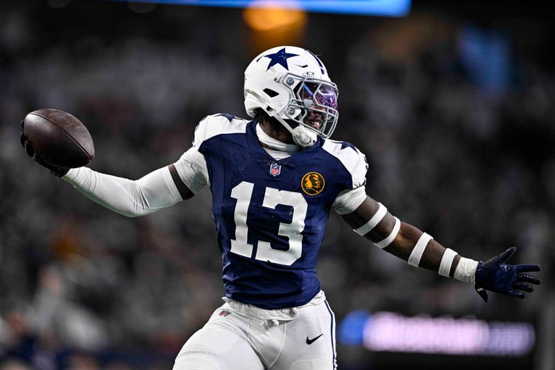 Dallas Cowboys linebacker DeMarvion Overshown (13) celebrates as he runs in for a touchdown on an interception against the New York Giants during the first half of an NFL football game in Arlington, Texas, Thursday, Nov. 28, 2024. (AP Photo/Jerome Miron)