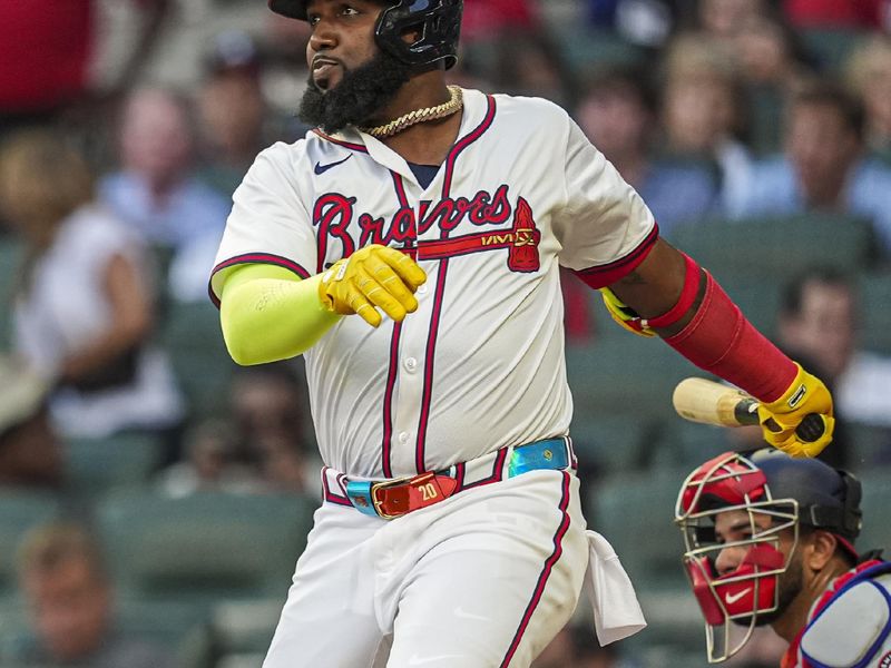 May 29, 2024; Cumberland, Georgia, USA; Atlanta Braves designated hitter Marcell Ozuna (20) drives in a run with a single against the Washington Nationals during the third inning at Truist Park. Mandatory Credit: Dale Zanine-USA TODAY Sports