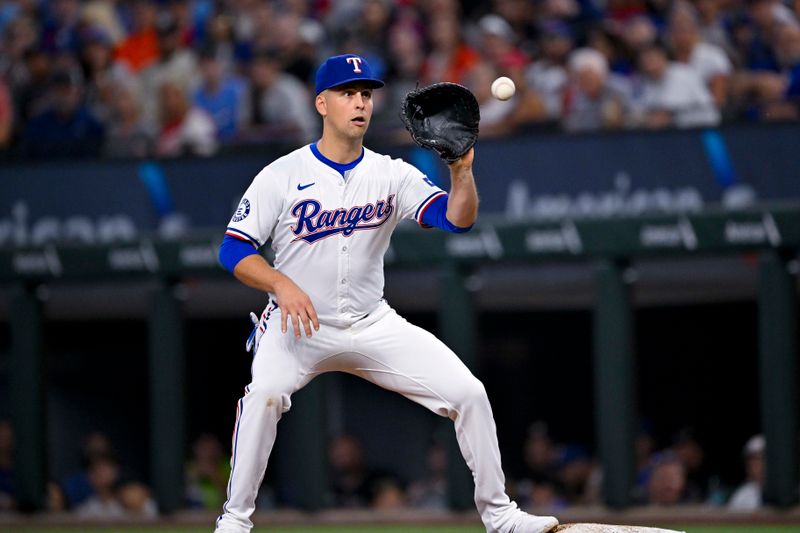 Aug 7, 2024; Arlington, Texas, USA;  Texas Rangers first baseman Nathaniel Lowe (30) fields a throw to first base during the fifth inning against the Houston Astros at Globe Life Field. Mandatory Credit: Jerome Miron-USA TODAY Sports