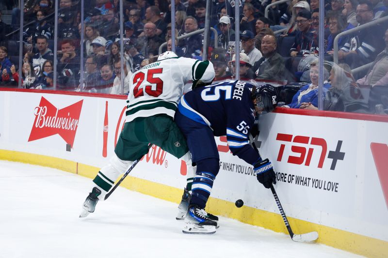 Oct 13, 2024; Winnipeg, Manitoba, CAN;  Minnesota Wild defenseman Jonas Brodin (25) and Winnipeg Jets forward Mark Scheifele (55) battle for the puck during the second period at Canada Life Centre. Mandatory Credit: Terrence Lee-Imagn Images