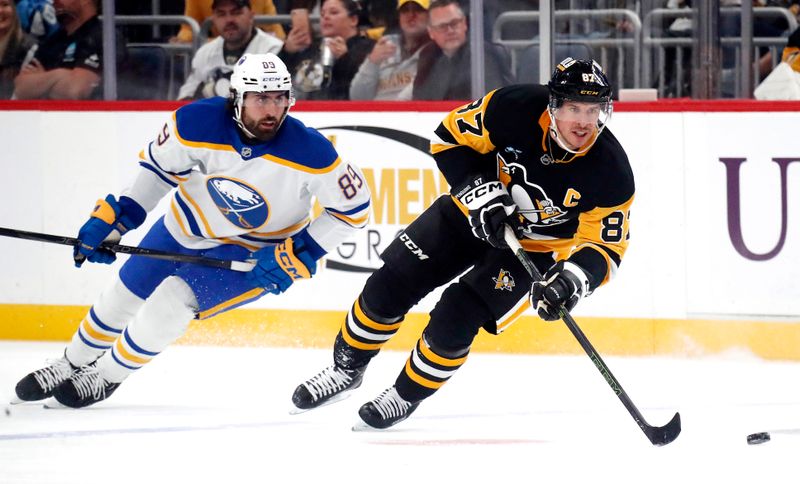 Oct 16, 2024; Pittsburgh, Pennsylvania, USA; Pittsburgh Penguins center Sidney Crosby (87) skates with the puck ahead of Buffalo Sabres right wing Alex Tuch (89) during the first period against at PPG Paints Arena. Mandatory Credit: Charles LeClaire-Imagn Images