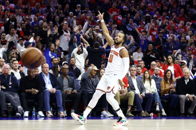 PHILADELPHIA, PENNSYLVANIA - APRIL 25: Jalen Brunson #11 of the New York Knicks reacts after scoring against the Philadelphia 76ers during the first quarter game three of the Eastern Conference First Round Playoffs at the Wells Fargo Center on April 25, 2024 in Philadelphia, Pennsylvania. NOTE TO USER: User expressly acknowledges and agrees that, by downloading and/or using this Photograph, user is consenting to the terms and conditions of the Getty Images License Agreement. (Photo by Tim Nwachukwu/Getty Images)