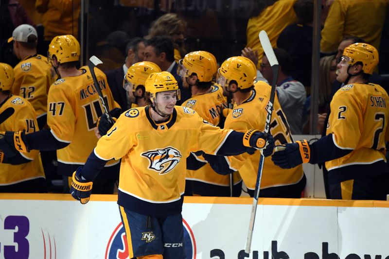 Mar 2, 2024; Nashville, Tennessee, USA; Nashville Predators center Cody Glass (8) celebrates with his teammates after a goal during the second period against the Colorado Avalanche at Bridgestone Arena. Mandatory Credit: Christopher Hanewinckel-USA TODAY Sports