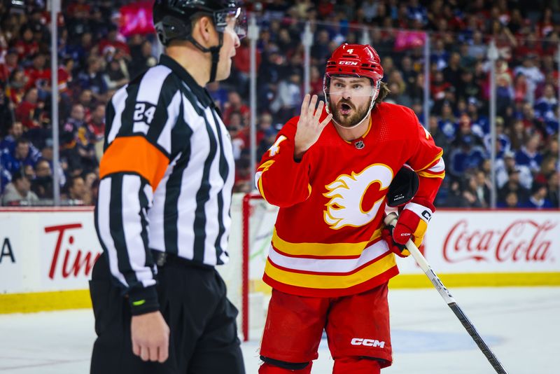 Jan 18, 2024; Calgary, Alberta, CAN; Calgary Flames defenseman Rasmus Andersson (4) and referee Graham Skilliter (24) exchanges words during the third period at Scotiabank Saddledome. Mandatory Credit: Sergei Belski-USA TODAY Sports