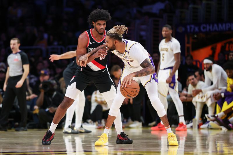 LOS ANGELES, CALIFORNIA - DECEMBER 08: D'Angelo Russell #1 of the Los Angeles Lakers handles the ball defended by Scoot Henderson #00 of the Portland Trail Blazers in the first half at Crypto.com Arena on December 08, 2024 in Los Angeles, California. NOTE TO USER: User expressly acknowledges and agrees that, by downloading and or using this Photograph, user is consenting to the terms and conditions of the Getty Images License Agreement. (Photo by Meg Oliphant/Getty Images)