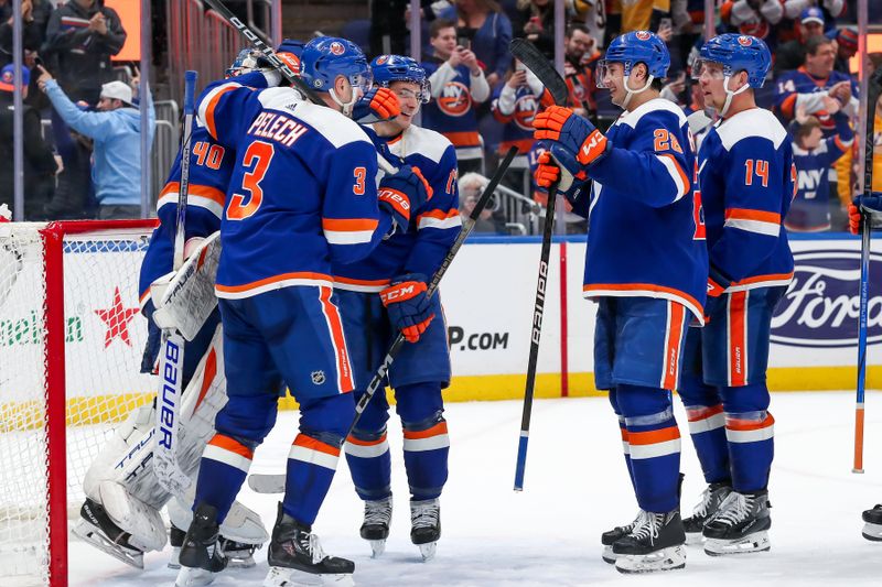 Apr 6, 2024; Elmont, New York, USA; New York Islanders celebrate after the game against the Nashville Predators at UBS Arena. Mandatory Credit: Tom Horak-USA TODAY Sports