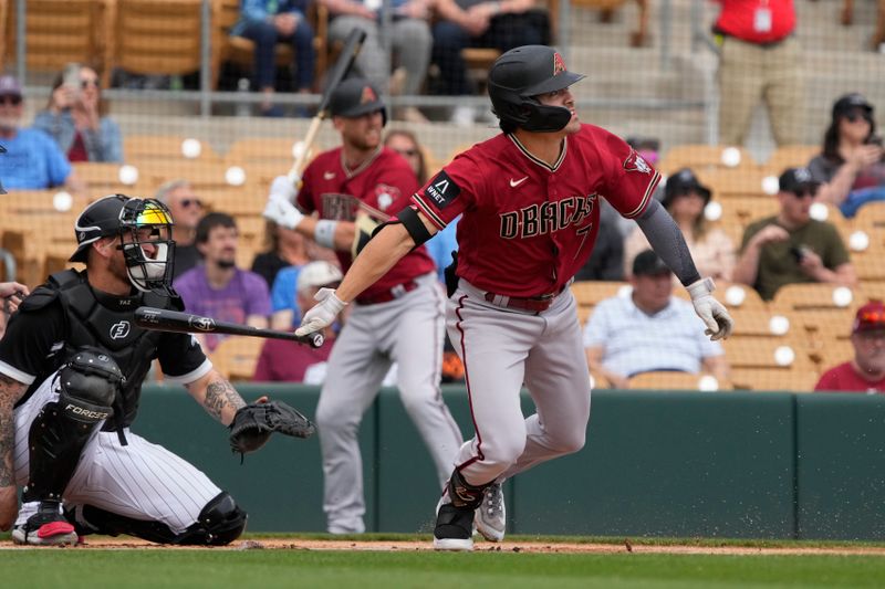 Mar 20, 2023; Phoenix, Arizona, USA; Arizona Diamondbacks left fielder Corbin Carroll (7) hits a double against the Chicago White Sox in the first inning at Camelback Ranch-Glendale. Mandatory Credit: Rick Scuteri-USA TODAY Sports