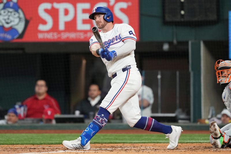 Jun 17, 2024; Arlington, Texas, USA; Texas Rangers designated hitter Robbie Grossman (4) follows through on a two-run home run against the New York Mets during the third inning at Globe Life Field. Mandatory Credit: Jim Cowsert-USA TODAY Sports